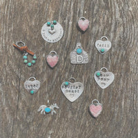 Assorted handmade sterling silver pendants and charms